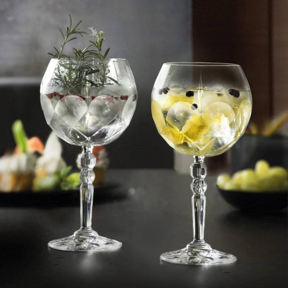 Crystal gin goblets filled with tonic and ice.