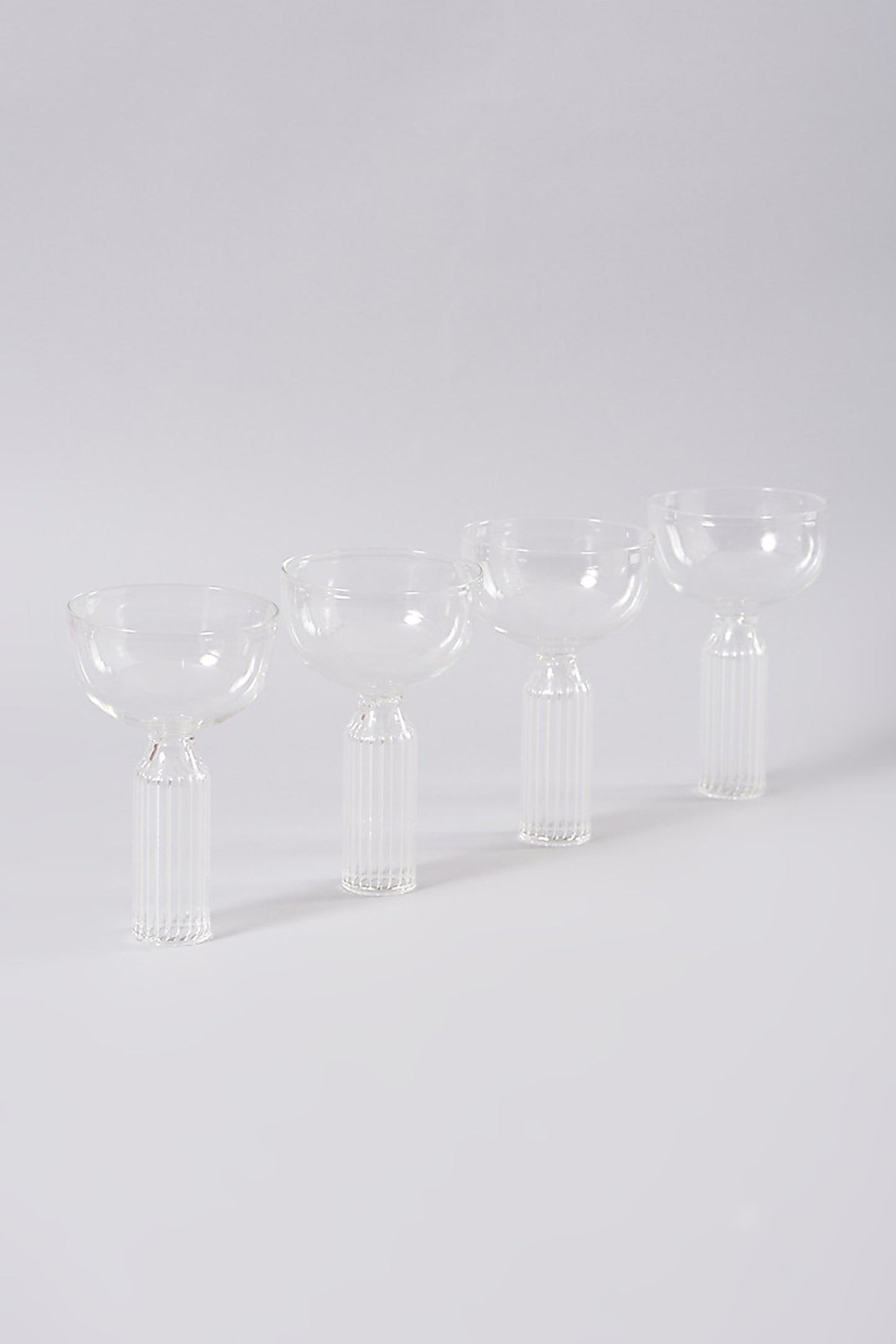 Set of four stem cocktail glasses with ribbed detail.