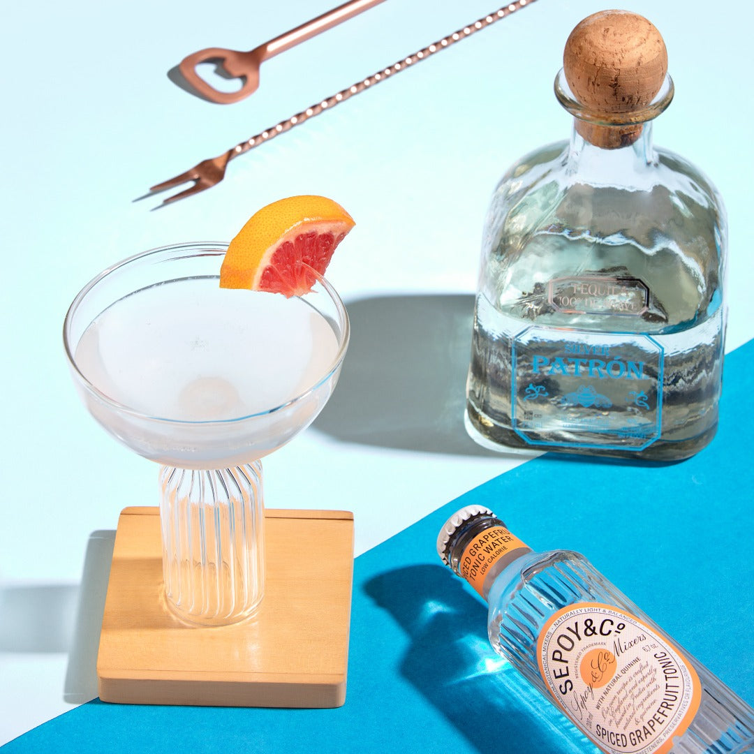 Stem cocktail glass with grapefruit garnish and ribbed stem.