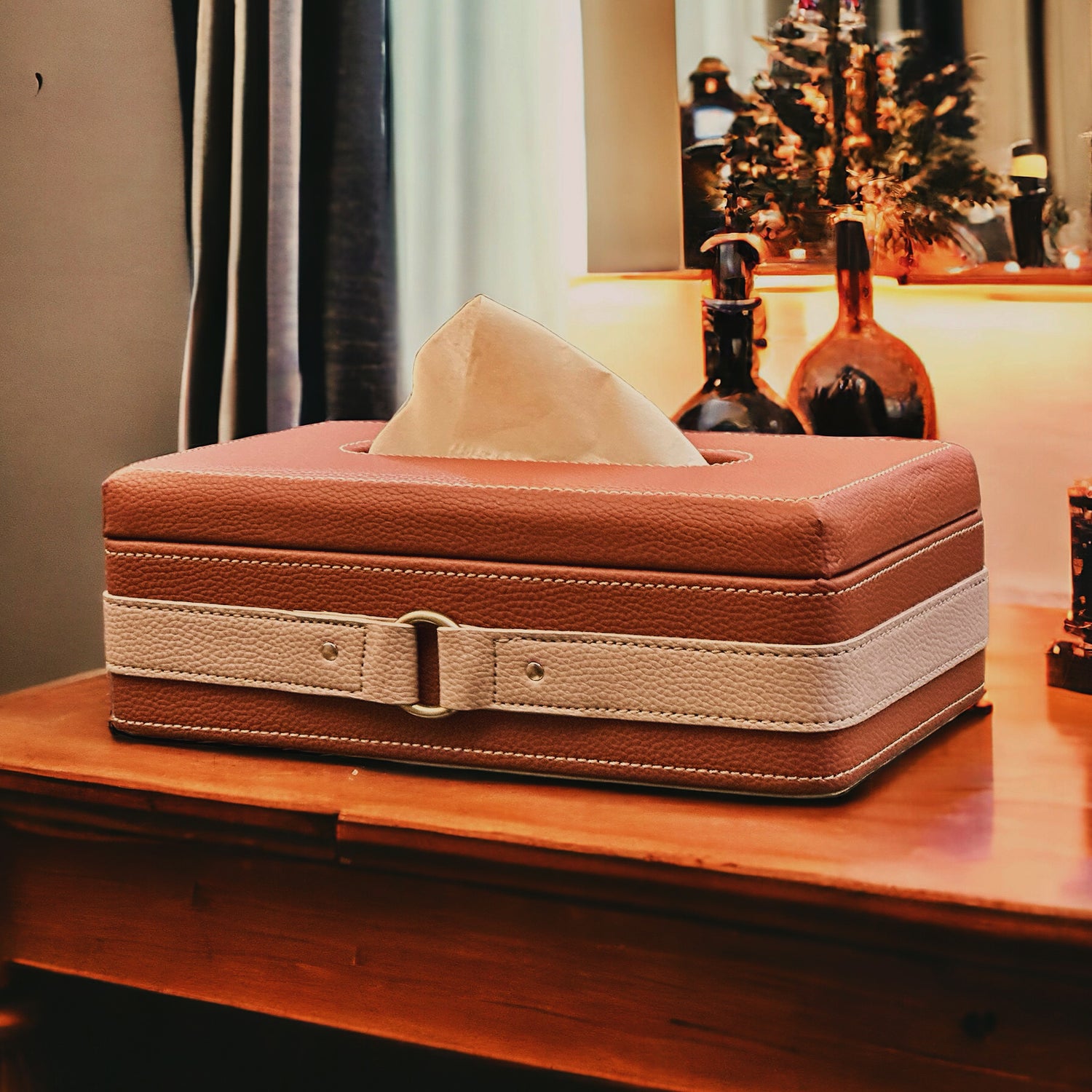 Cognac leather tissue box with accent strap detail.
