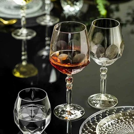 Alkemist wine glasses with geometric design and decorative stem.