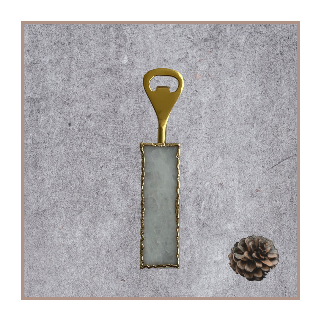 White quartz bottle opener with gold trim and hardware.