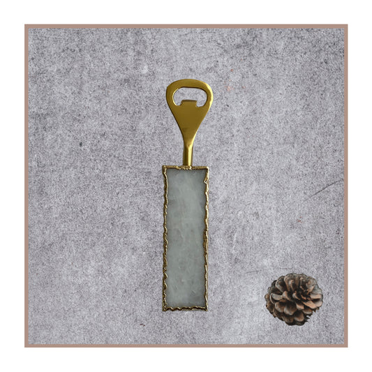 White quartz bottle opener with gold trim and hardware.