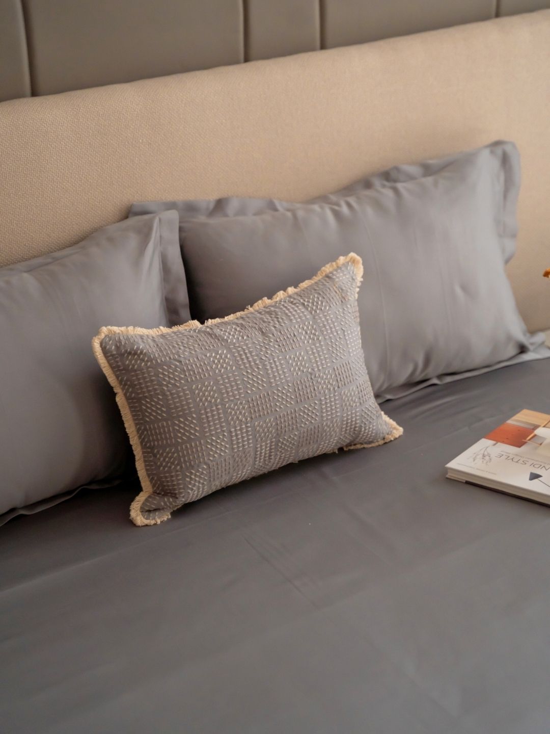 Slate grey bedsheet set styled on a bed with matching pillow covers