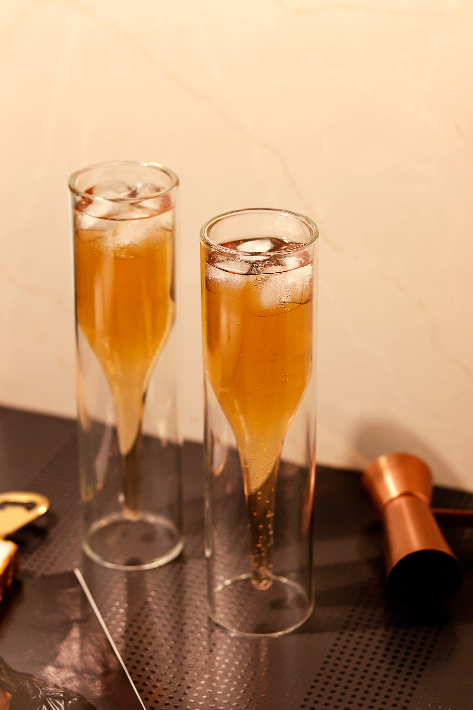 Two double walled flute glasses filled with iced drinks.