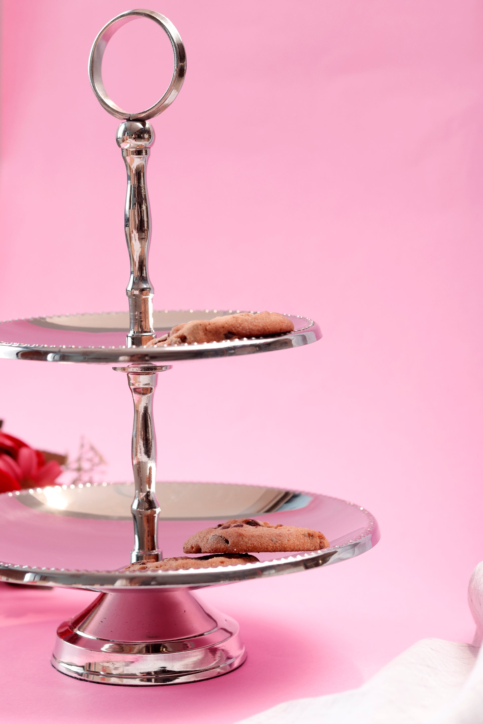 Elegant metal two tier cake stand with cookies.