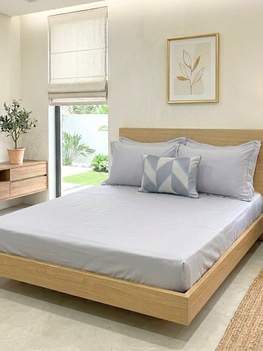 Stacy smoke blue bedsheet set with accent cushion styled on bed