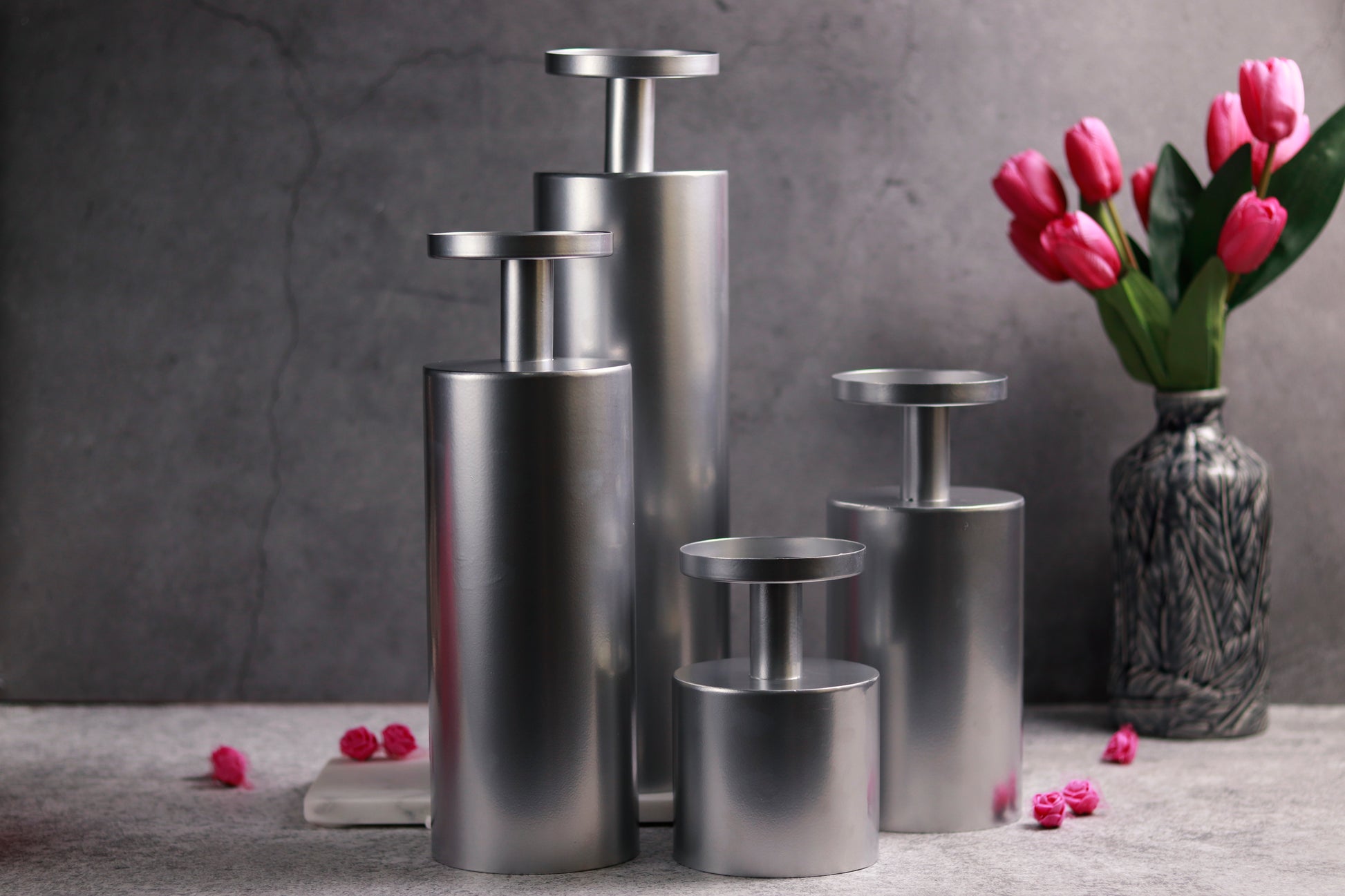 Magnolia chrome candle stands in varying sizes with shiny finish.