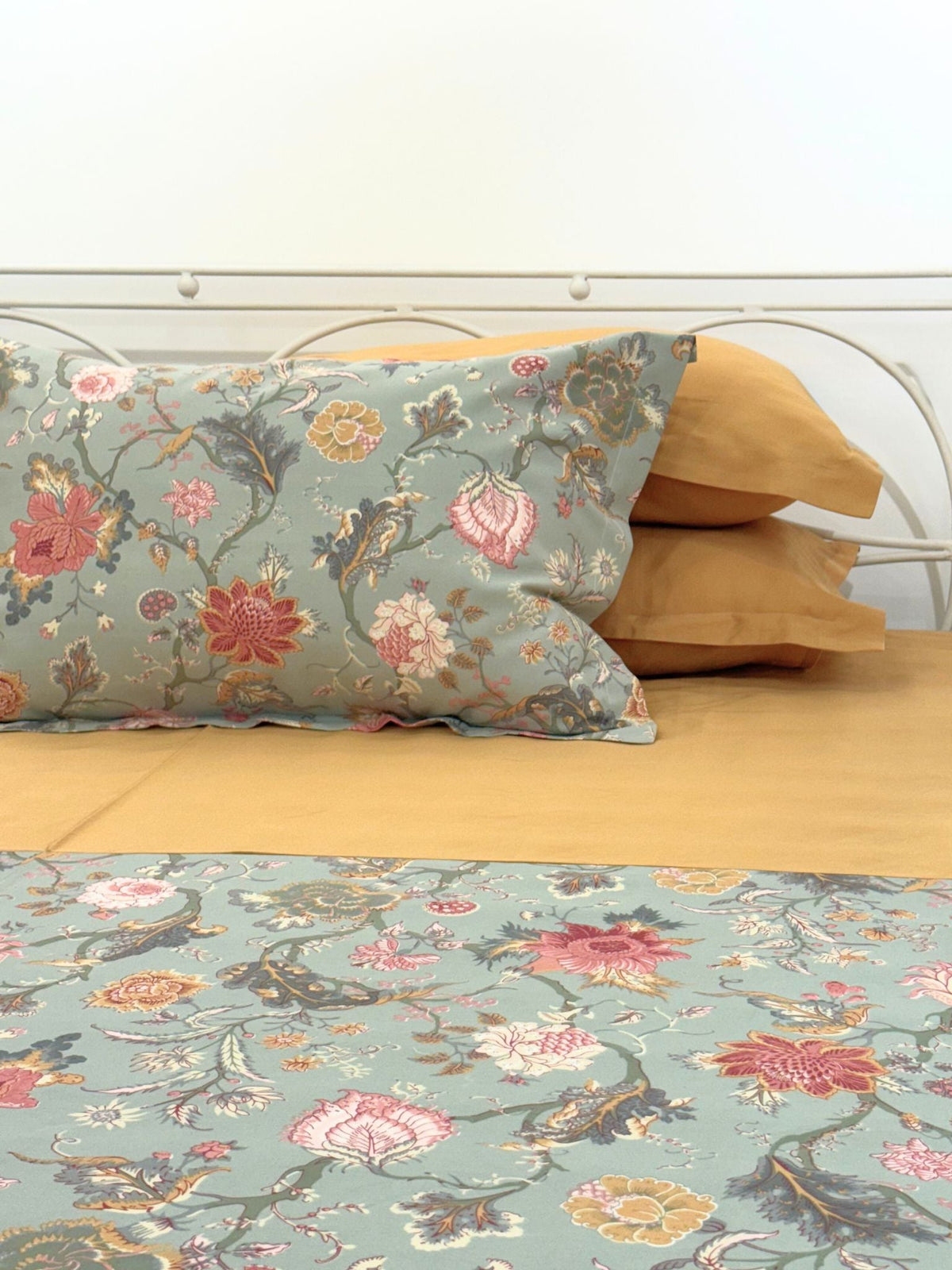 Coco sage green and honey mustard bedsheet set styled on bed