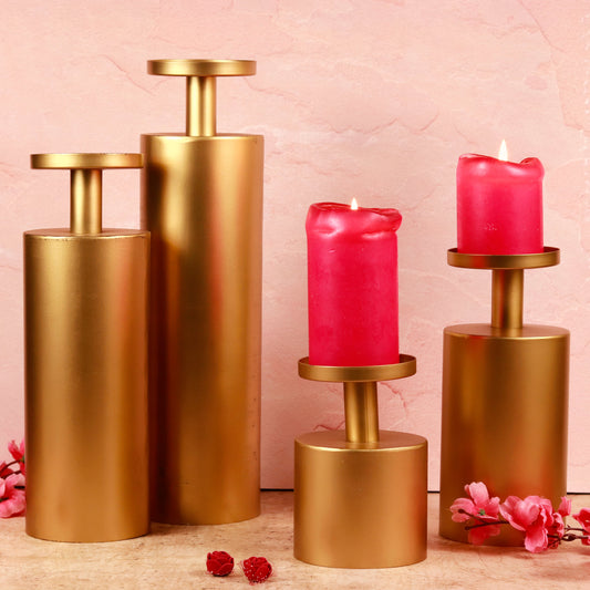 Magnolia gold candle stands set with lit red candles