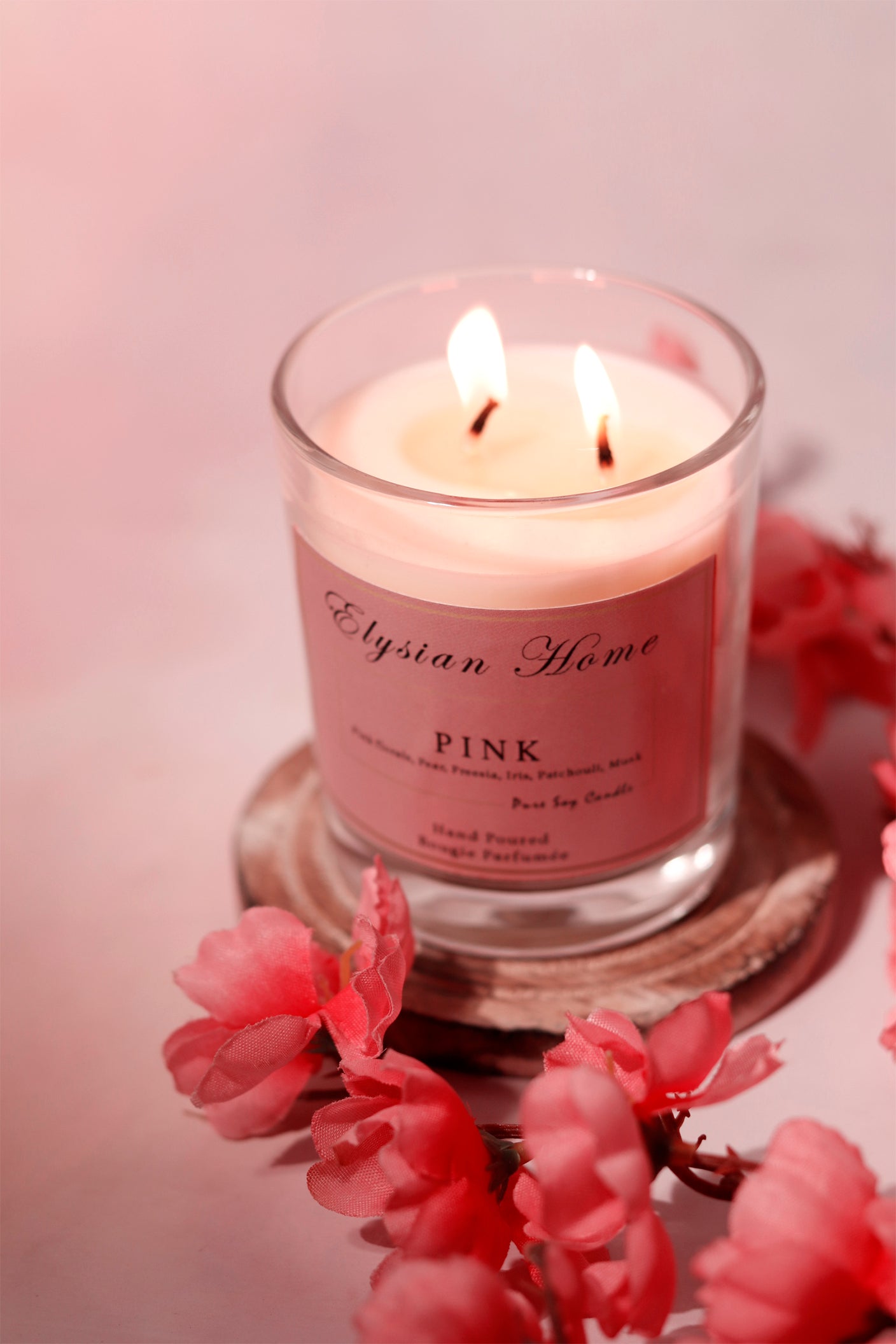 Elegant soy candle with pink floral accents; Elysian Home.
