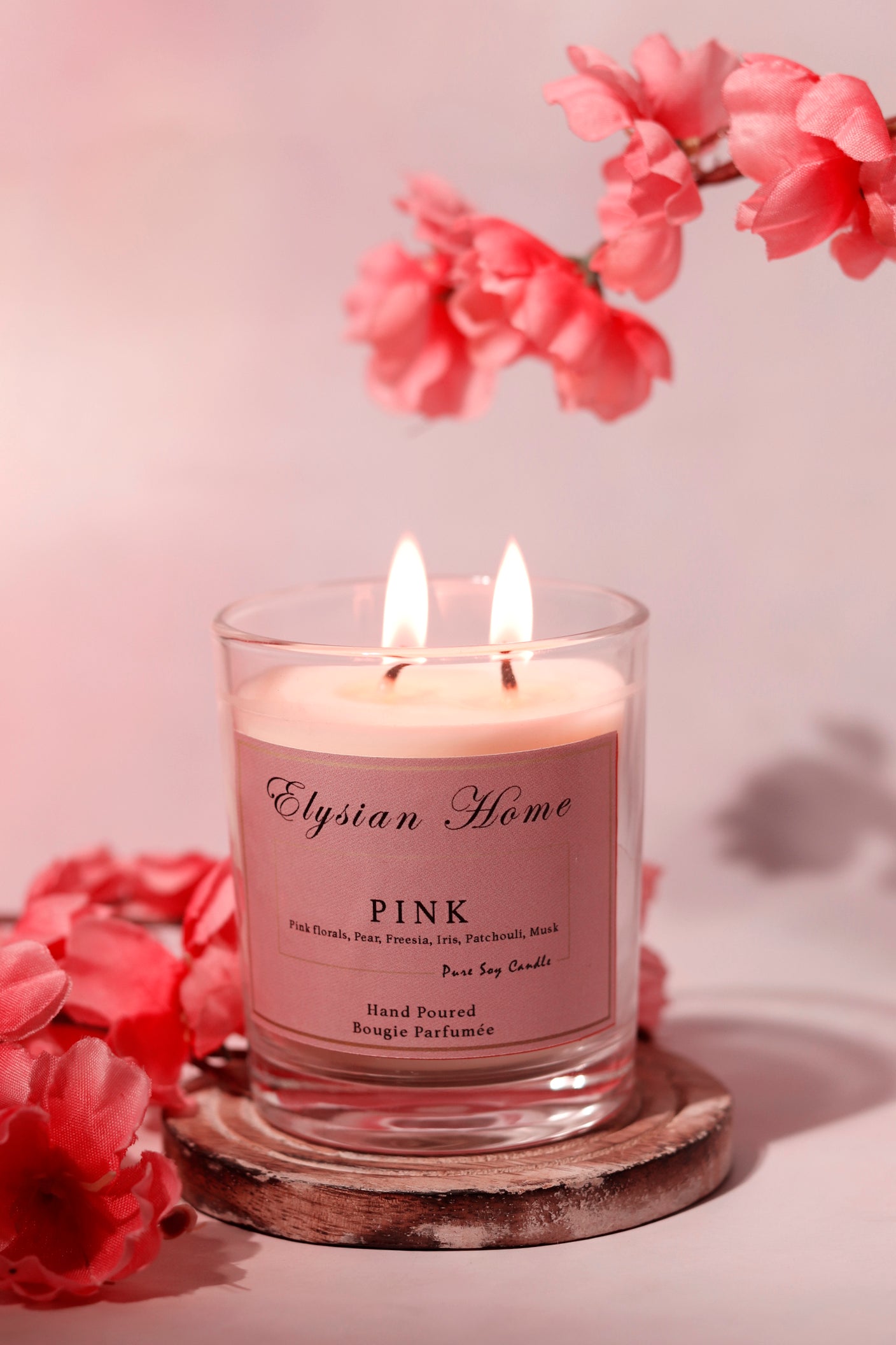 Lit pink floral candle, pure soy candle with floral accents.