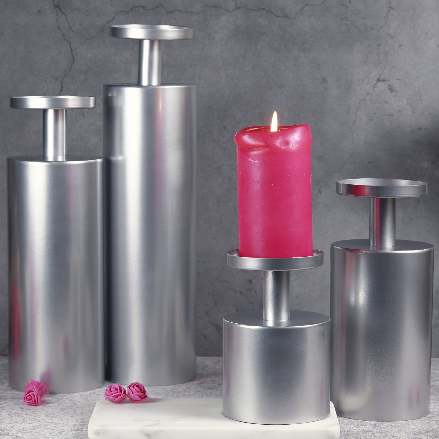 Elegant chrome candle stand with a lit candle