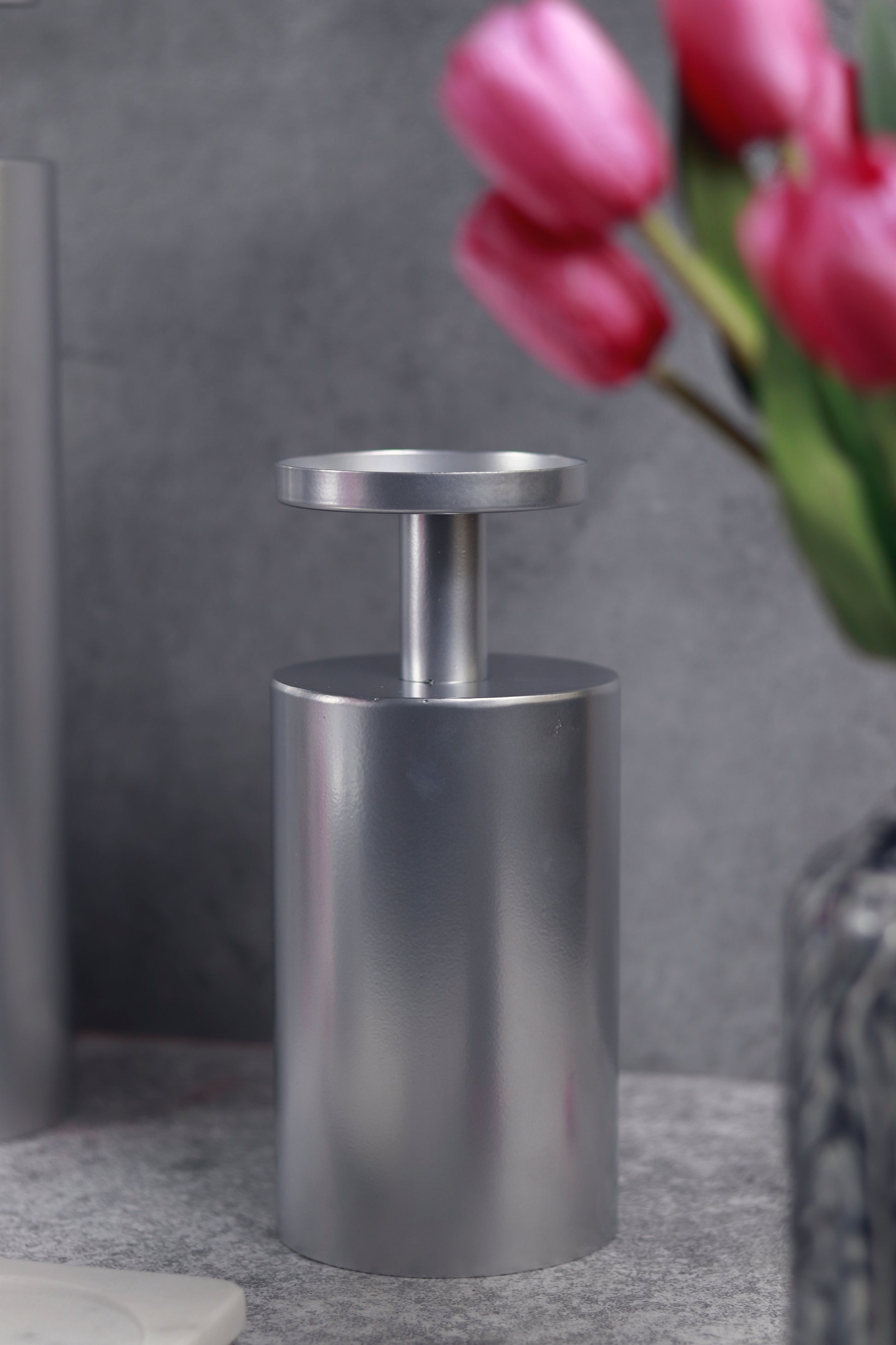 Elegant chrome candle stand with a modern, minimalist design.