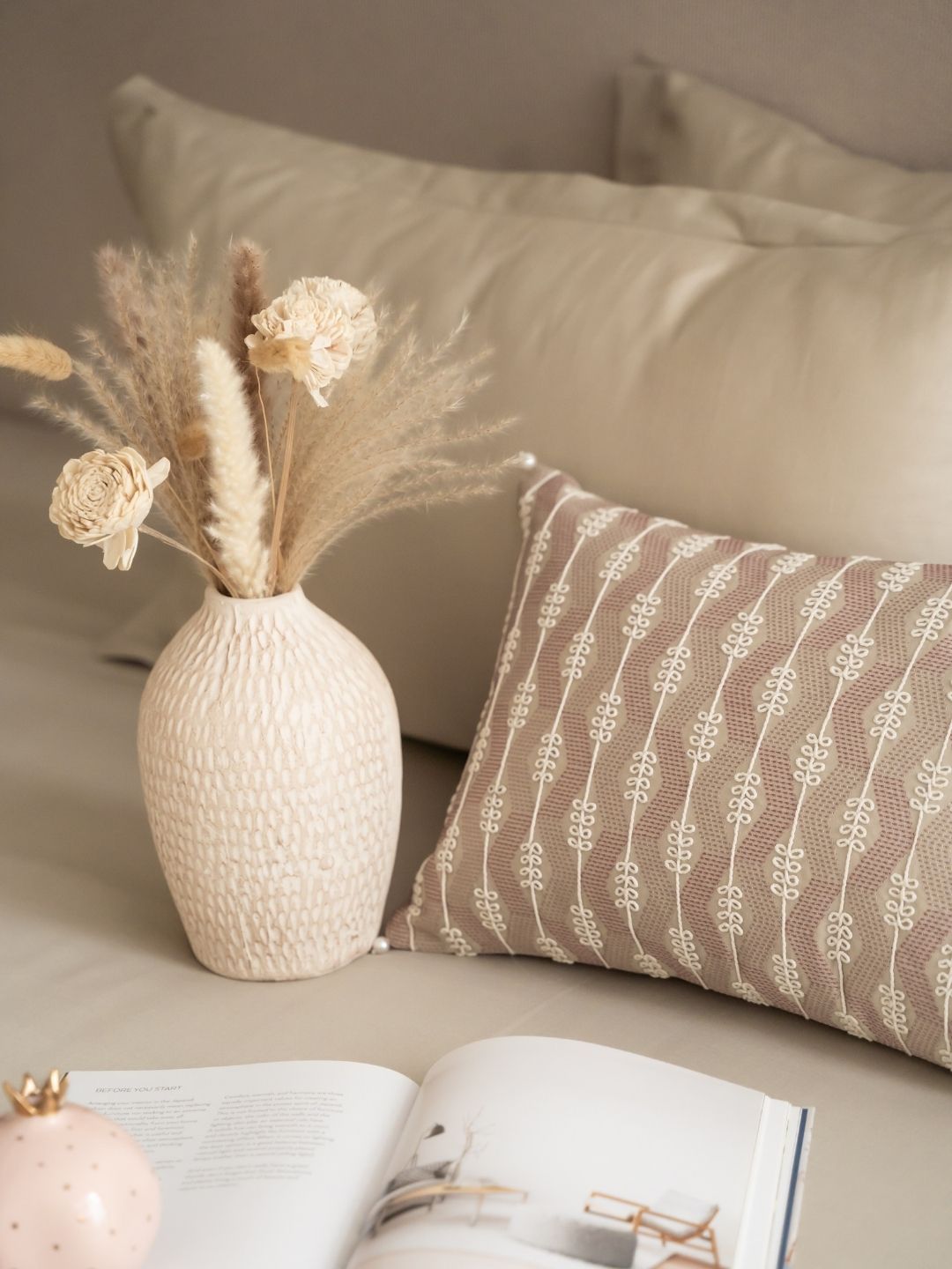 Beige bedsheet set styled on a bed