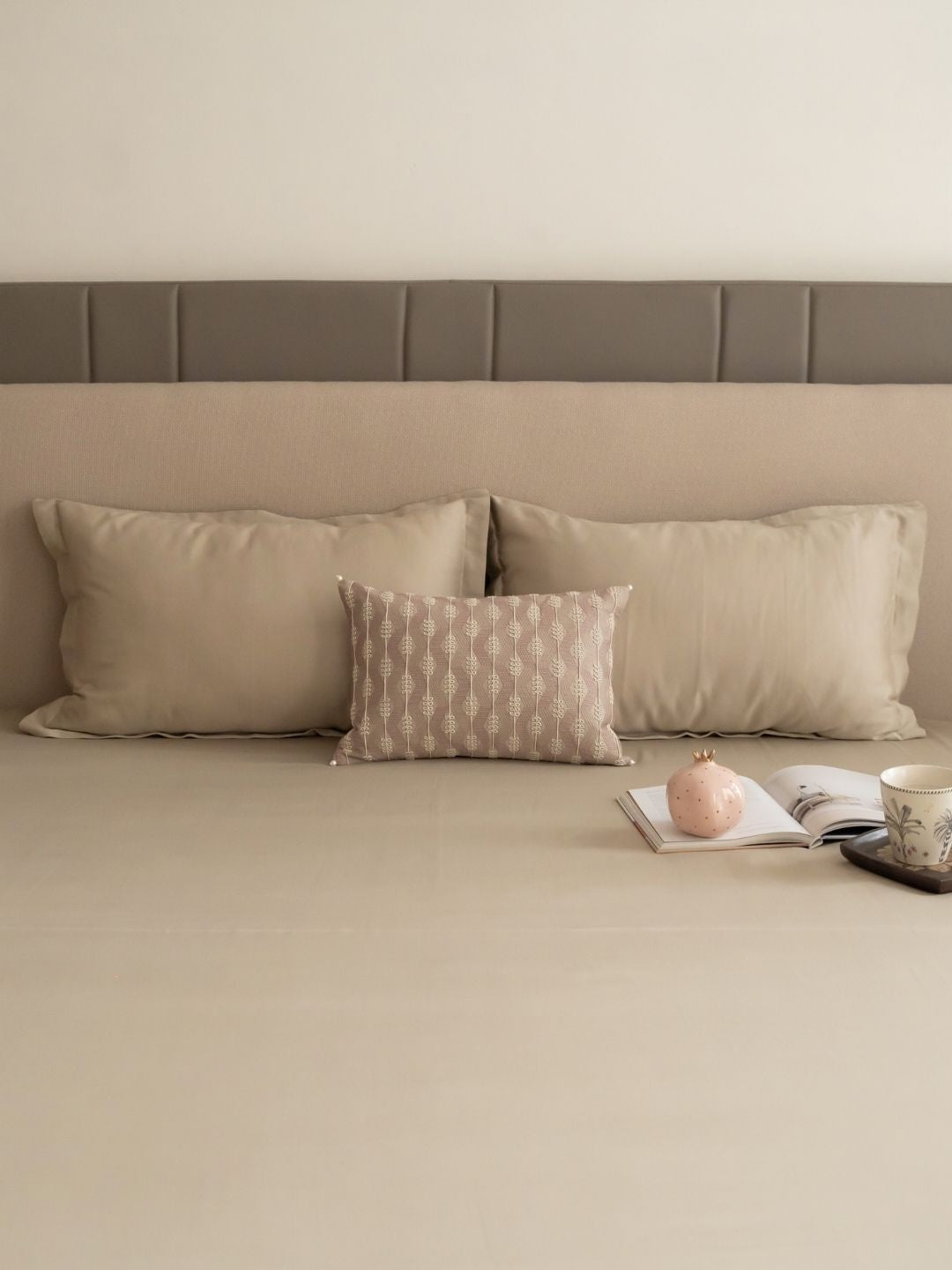 Full bed styled with beige treasure bedsheet set
