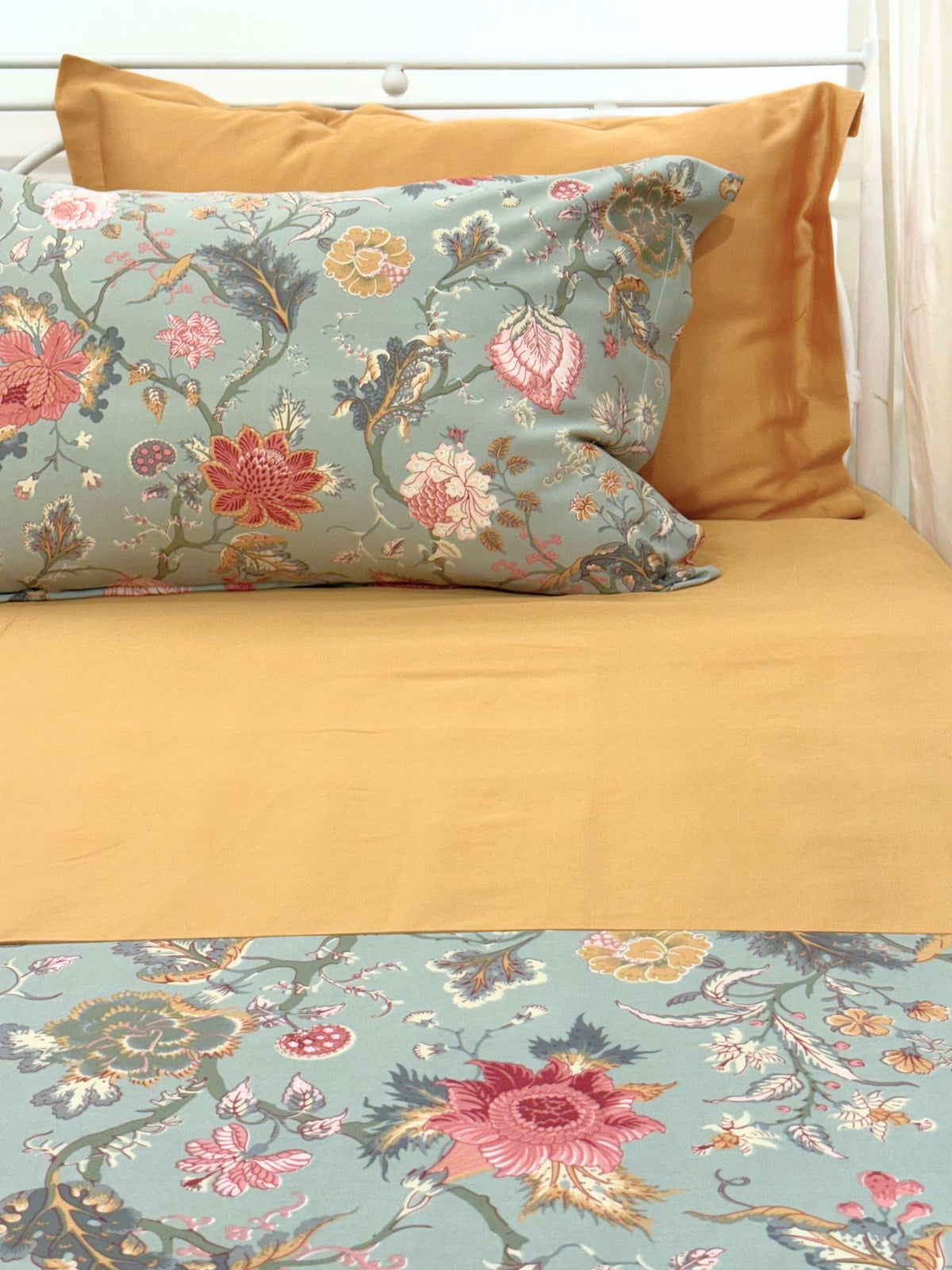 Printed and solid pillow covers in sage green and honey mustard