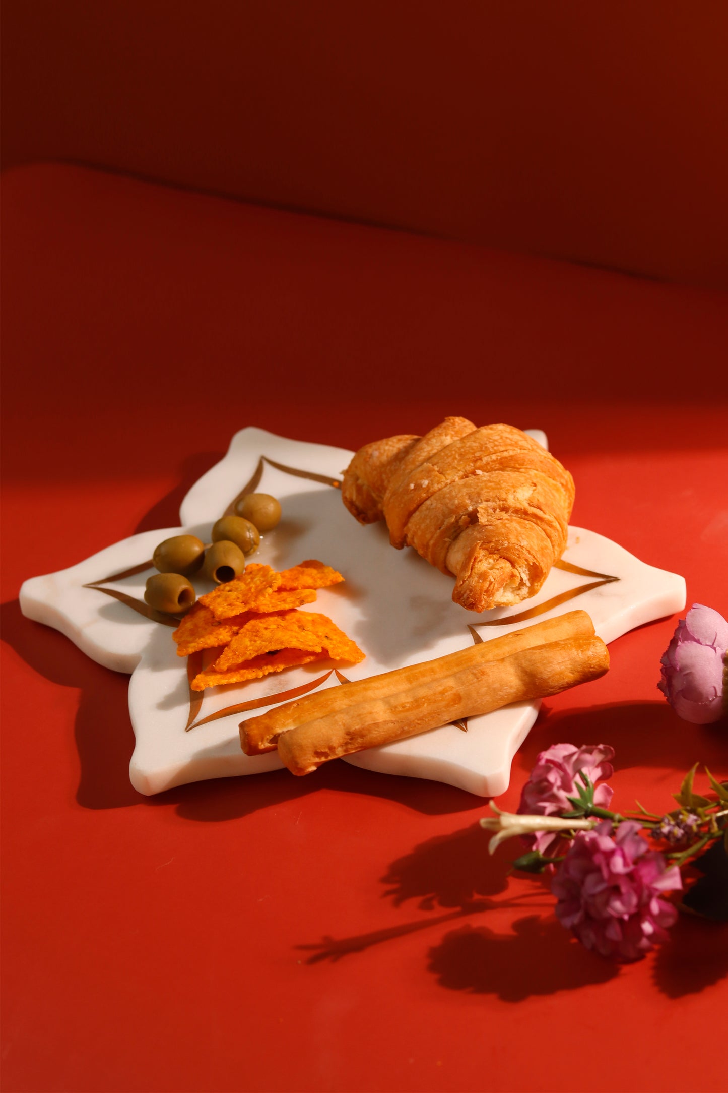 Lotus platter with brass inlay design holding snacks.