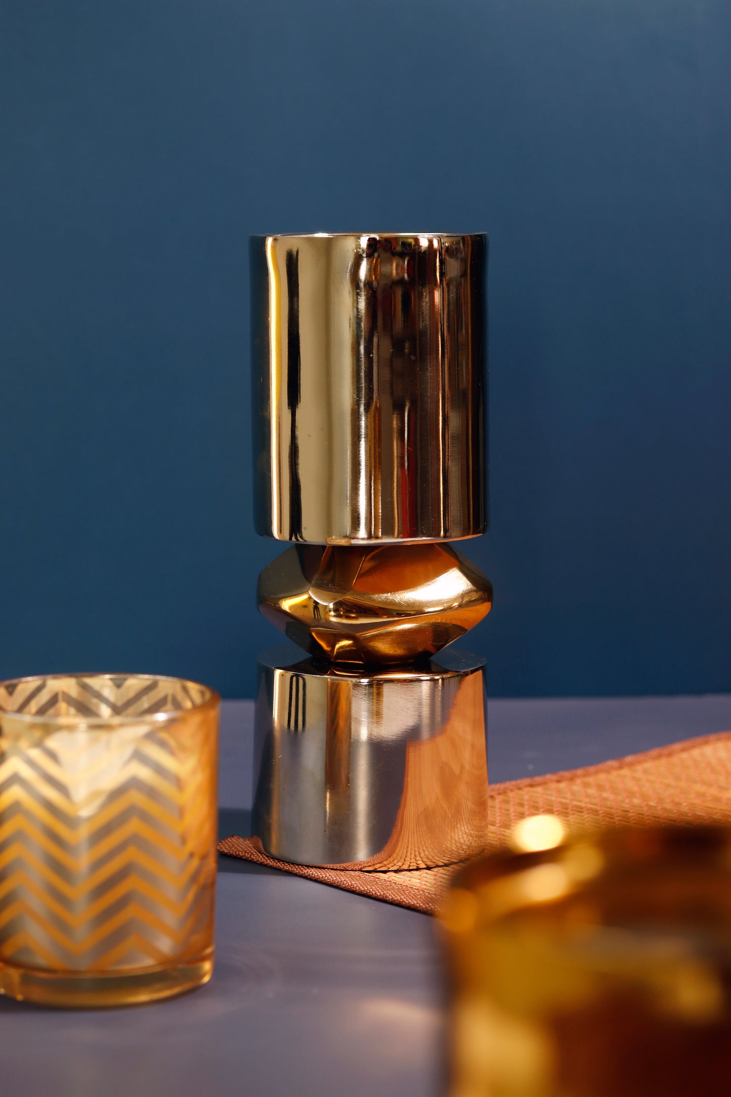 Stylish mixed metal gold and nickel candle stand.
