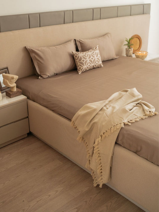 Azure mocha bedsheet set with accent cushion styled on bed