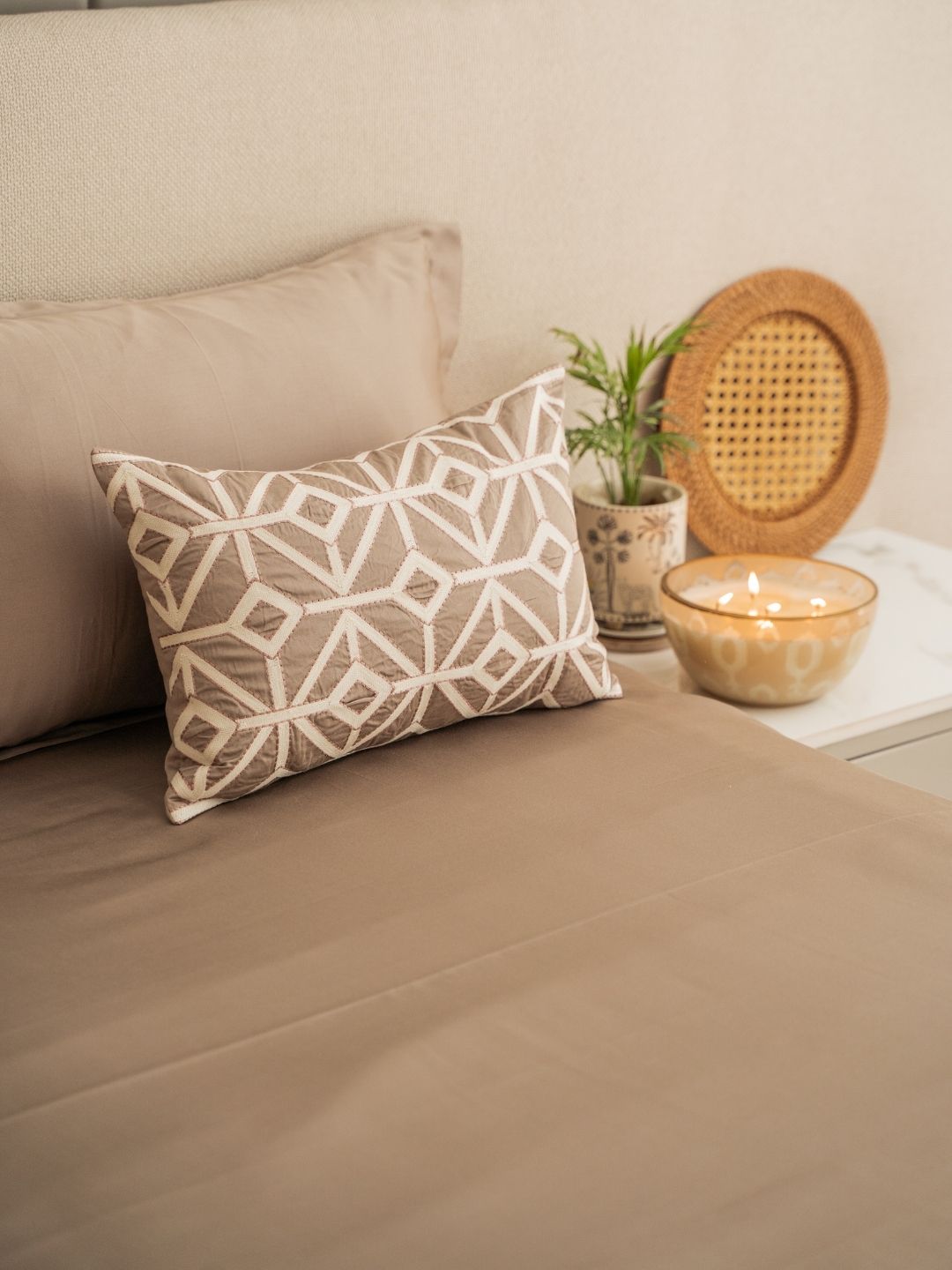 Close-up of mocha embroidered accent cushion cover