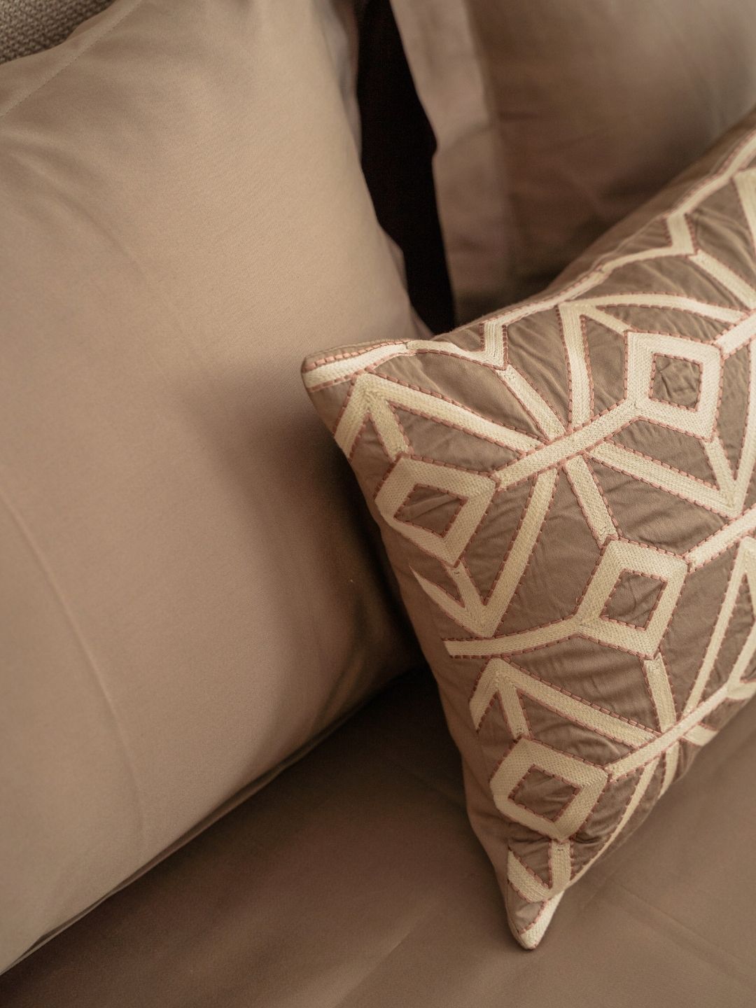 Azure mocha pillow covers arranged on bed