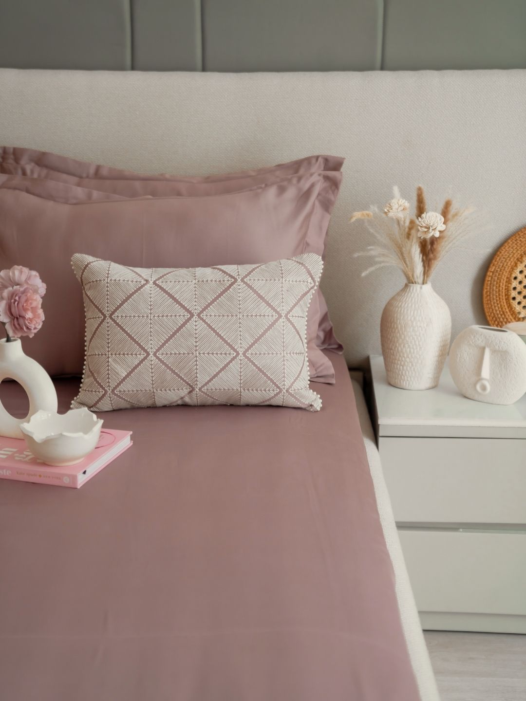 Old rose bedsheet set styled on a bed