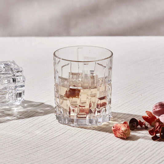 Etna whiskey glass with geometric design and beverage.