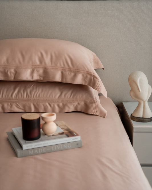 Creme pleated bamboo bedsheet set styled on bed