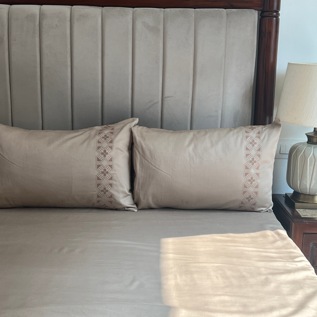 Allure sand bedsheet folded showing embroidery detail