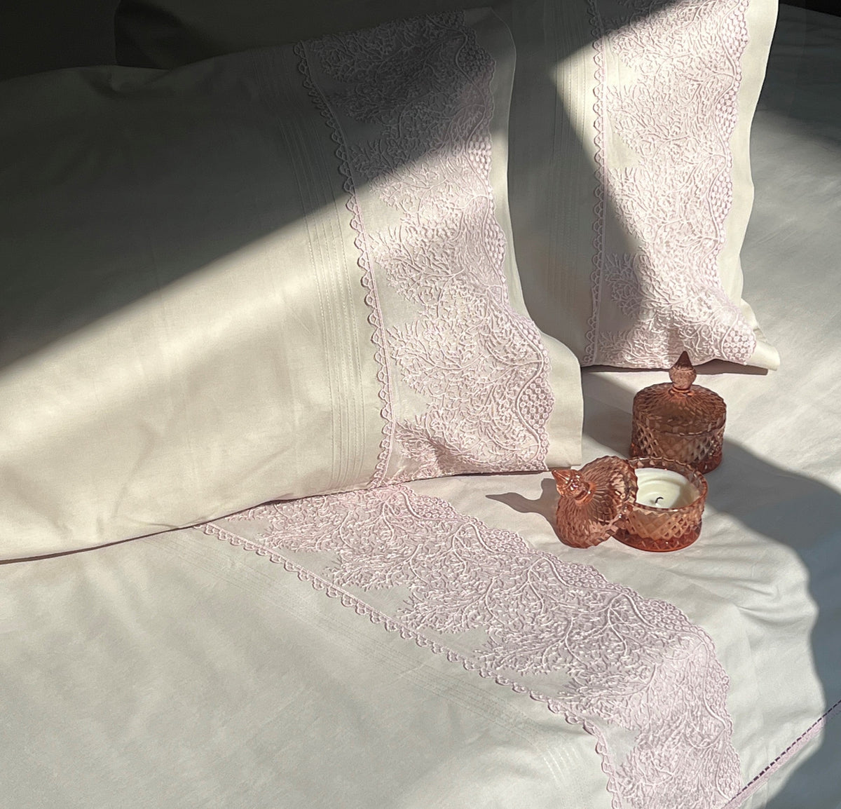 Close-up of embroidered lace detail on almond beige pillow cover