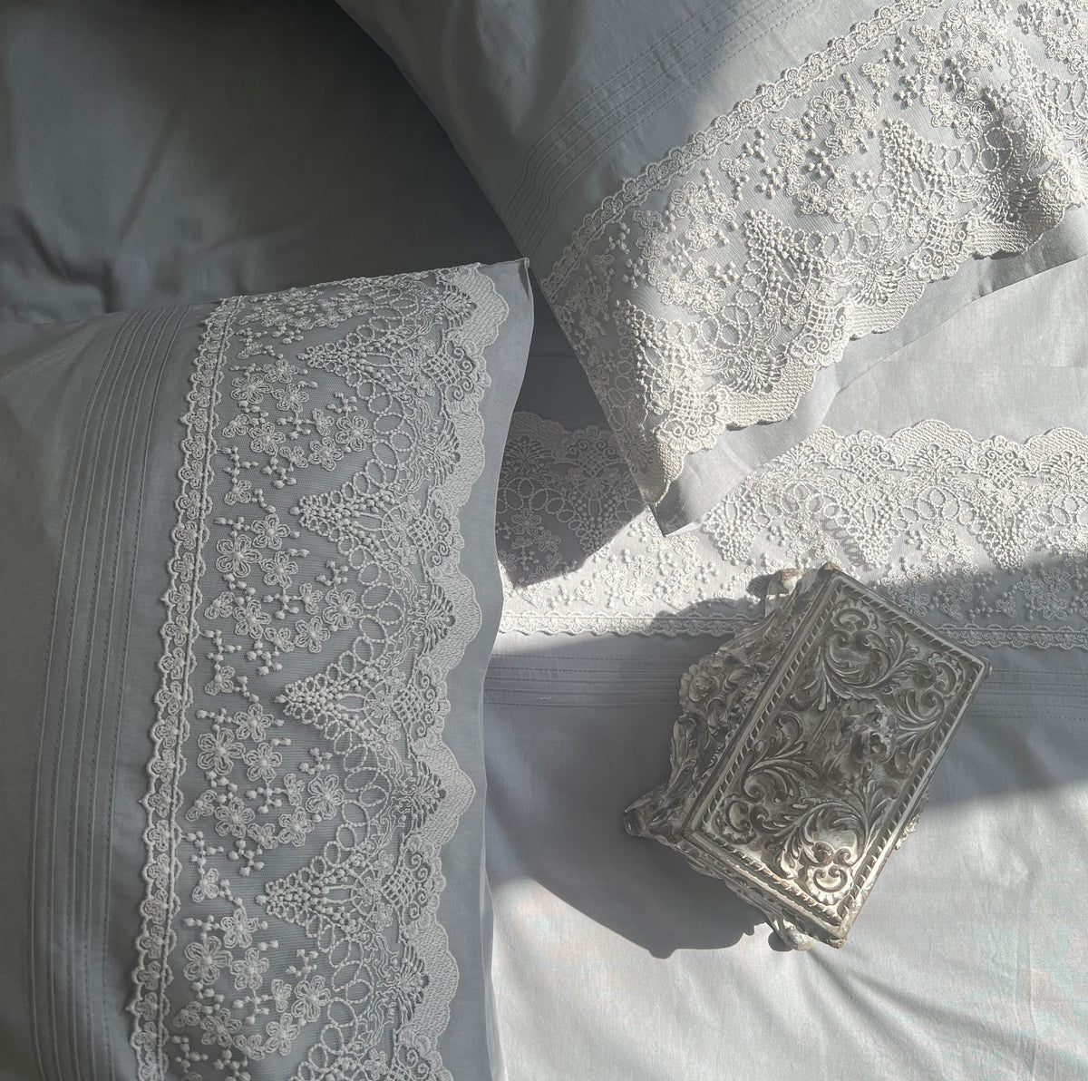 Close-up of slate embroidered lace pillow cover