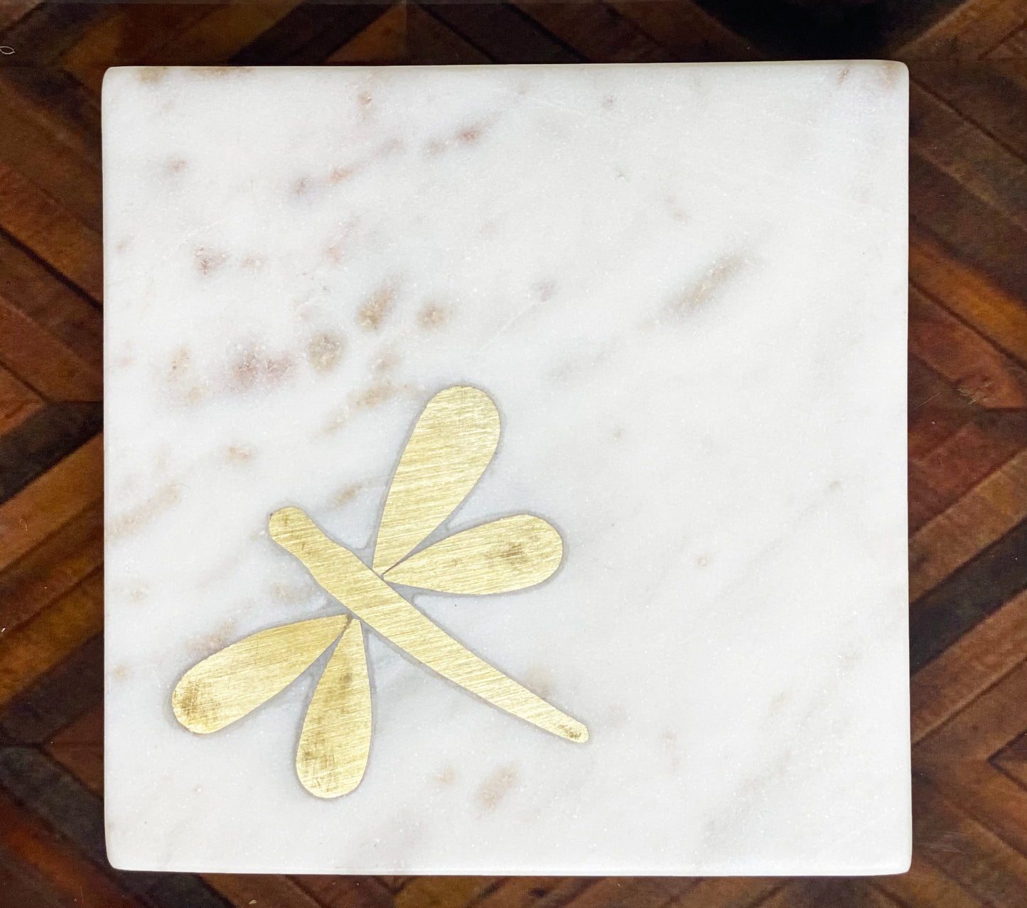 Marble coaster with brass dragonfly inlay detail.