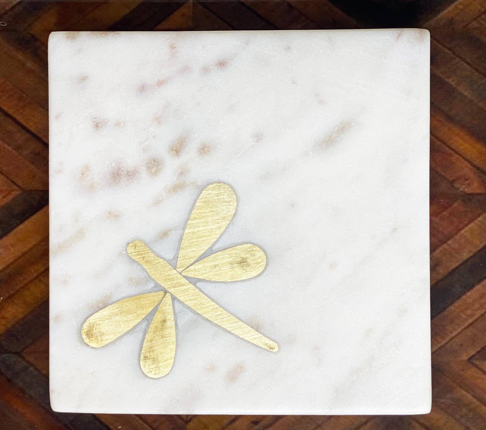 Marble coaster with brass dragonfly inlay detail.