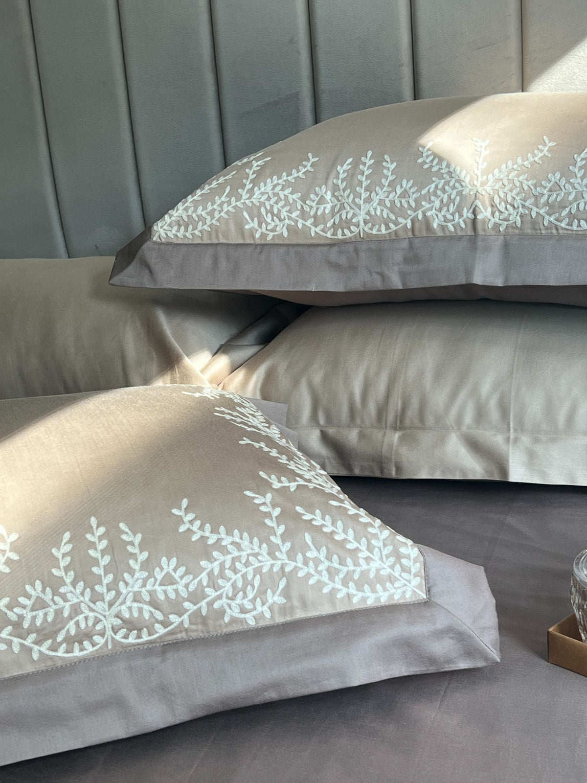 Close-up of sand taupe embroidered pillow cover
