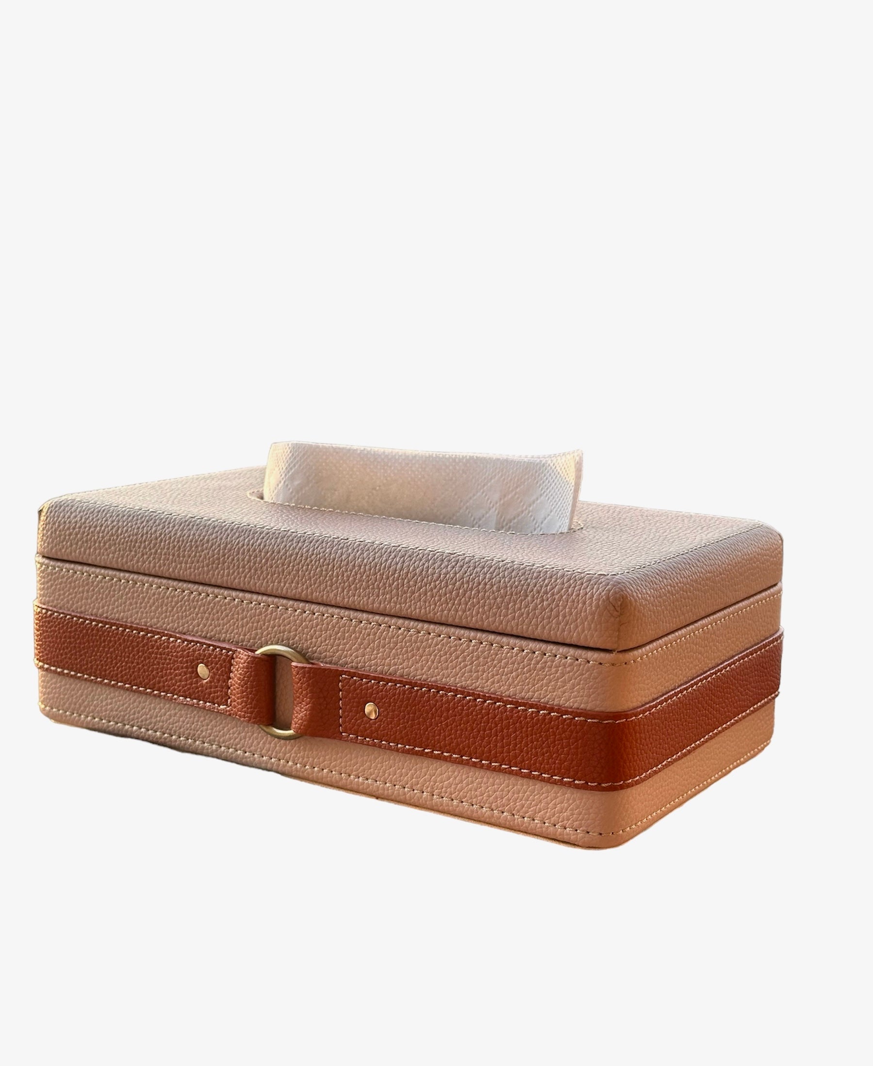 Beige leather tissue box with brown strap and metal buckle.
