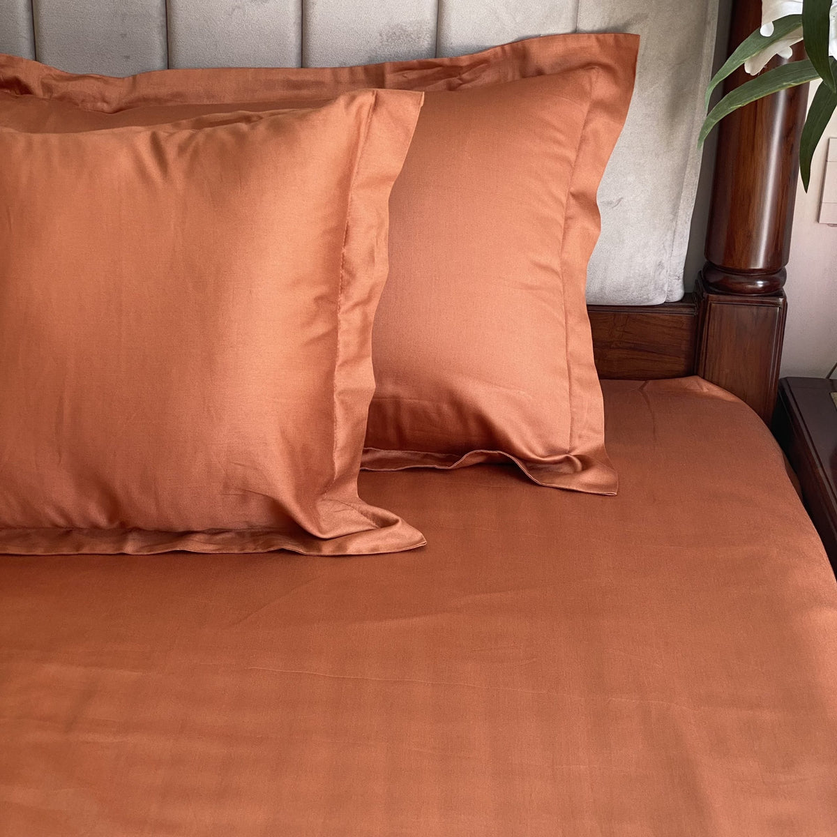 Rust pillow covers arranged on bed