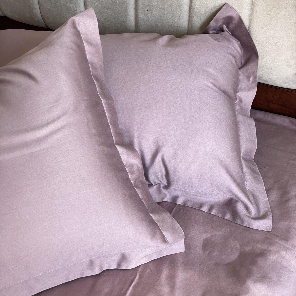 Old rose bedsheet styled on a made bed