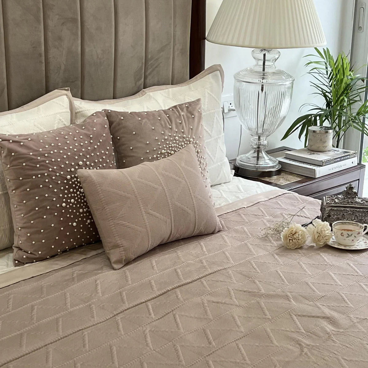 Buff & ivory cotton reversible bedspread with trigon design.