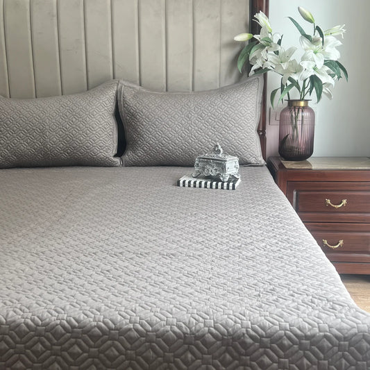Olive grey cotton bedspread with geometrical pattern and pillow covers.