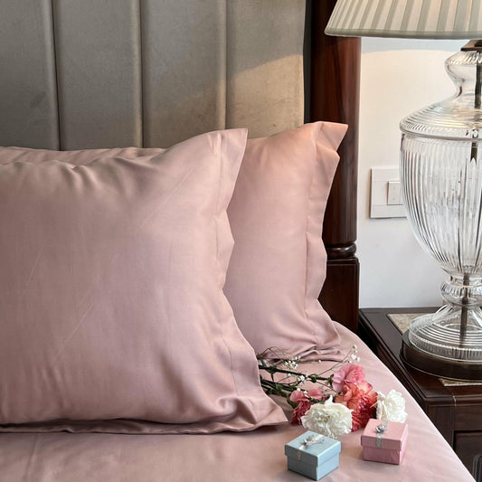 Rose bedsheet styled on a made bed