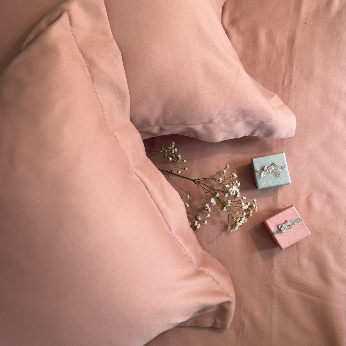 Rose pillow covers arranged on bed
