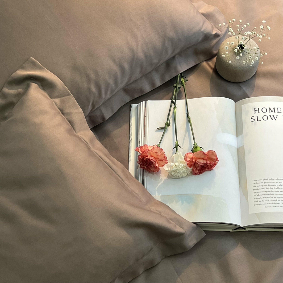 Taupe pillow covers arranged on bed