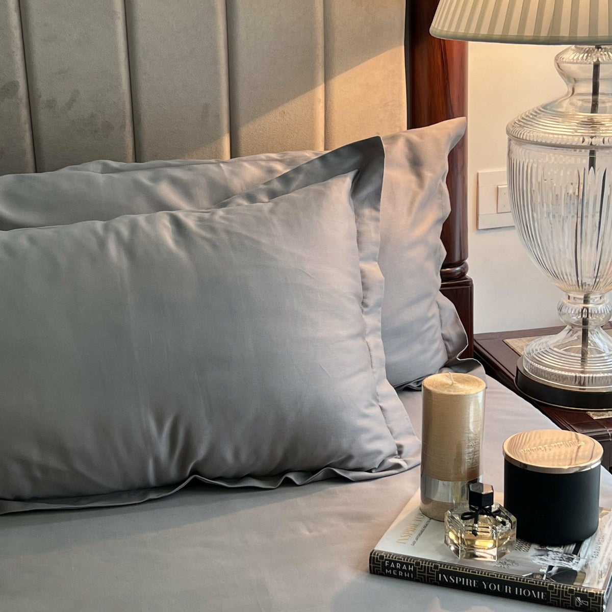 Slate grey bedsheet set styled on a made bed