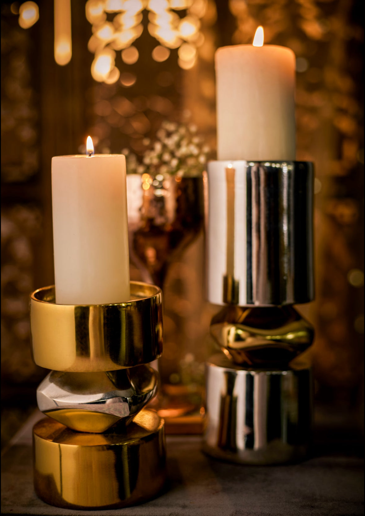 Metal candle stands in gold and nickel finish.