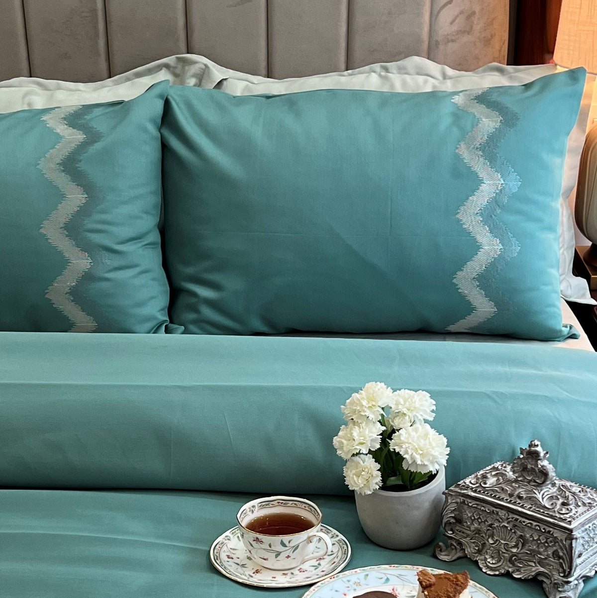 Close-up of turquoise embroidered pillow cover