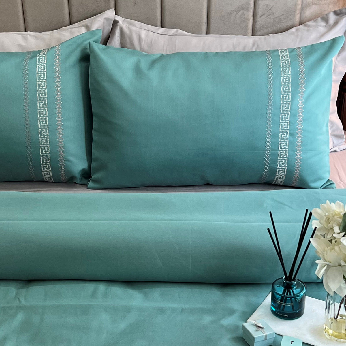 Close-up of turquoise embroidered pillow cover