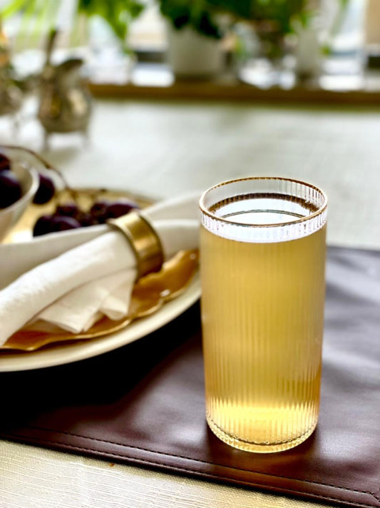 Ribbed highball glass with gold rim on elegant tablescape