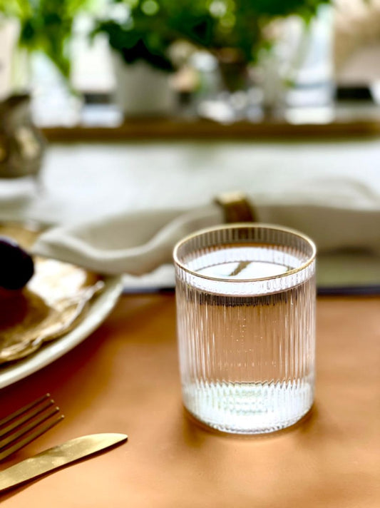 Ribbed glass with gold rim detail.