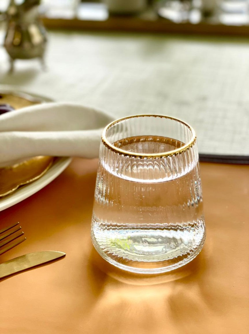 Fitzgerald tumbler glass with gold rim detail.